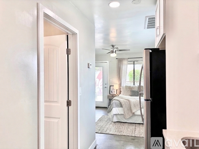 A modern kitchen with a stainless steel refrigerator, a microwave above the stove, and a sink with a faucet.