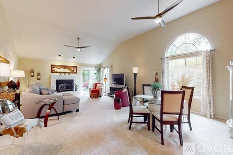 A living room with a fireplace and a dining table set up.