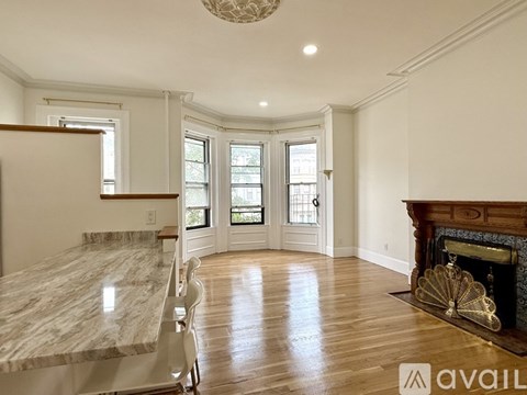 A living room with a grey couch and a wooden coffee table.