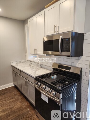 A kitchen with a stove top oven and microwave above it.