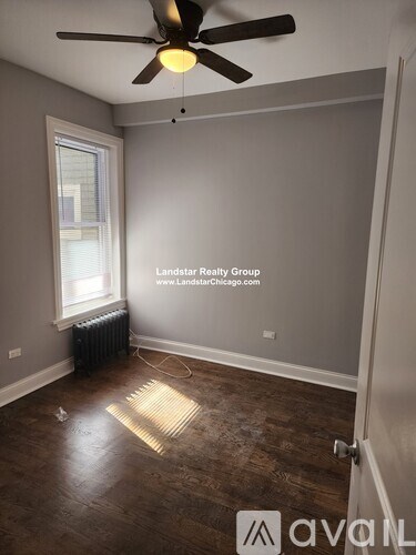 A room with a ceiling fan and a window.