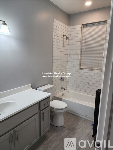 A bathroom with a white sink, toilet, and bathtub.