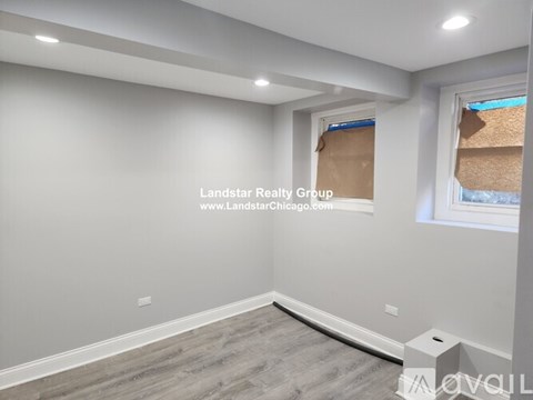 A room with a window covered by a brown paper.