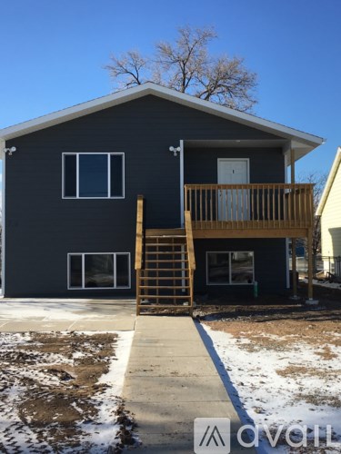A two-story house with a balcony and a deck.