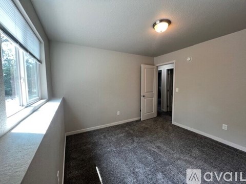 A stacked washer and dryer in a small space.