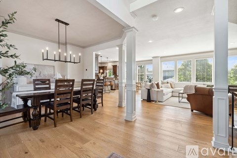 A living room with a dining table and chairs.