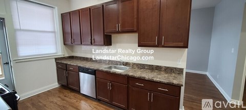 A kitchen with brown cabinets and a countertop.