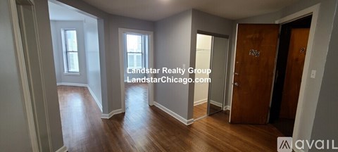 A room with wooden floors and a door with the number 905 on it.