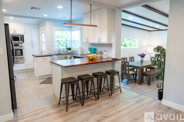 A kitchen with a bar area and a dining table.