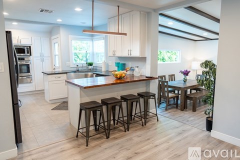 A kitchen with a bar area and a dining table.