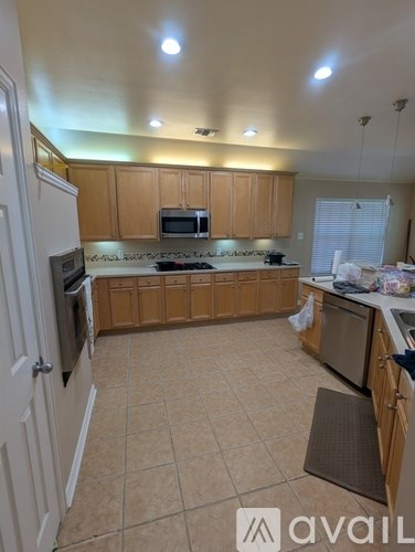 A kitchen with wooden cabinets and a white refrigerator.