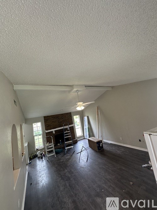 A room with a fireplace and a ladder in it.