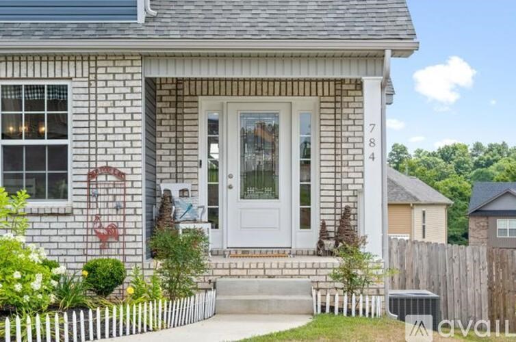 A house with a white door and windows with a number 784 on the side.