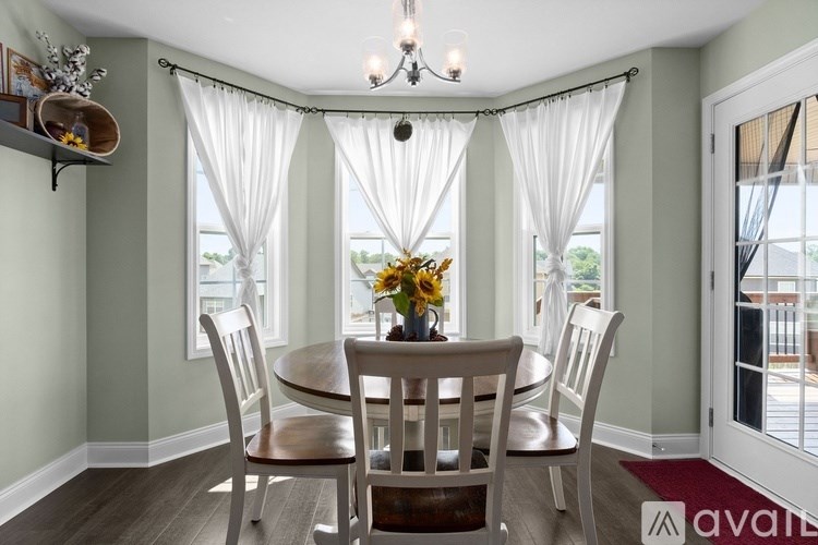 A dining room with a table set for four.