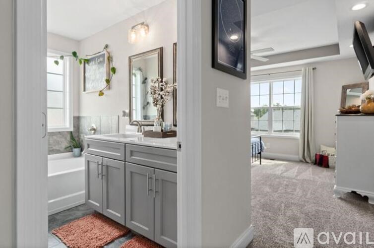 A bathroom with a large mirror and a bathtub.