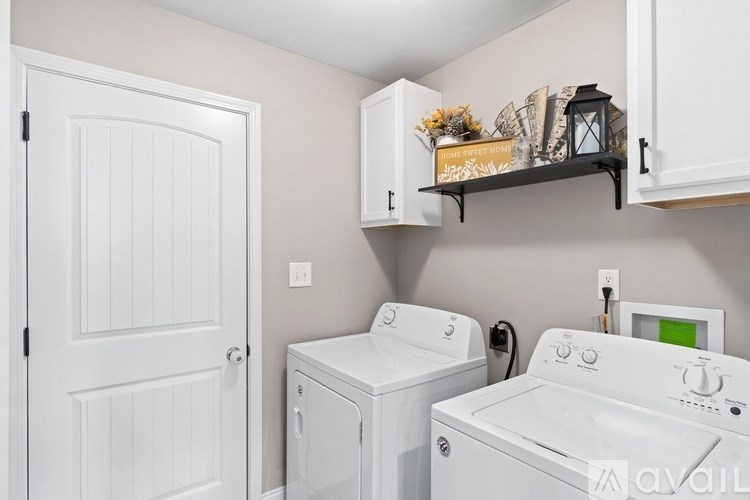 A small laundry room with a washer and dryer.