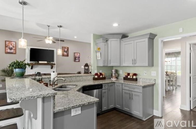 A kitchen with granite countertops and a large island.
