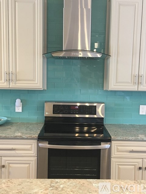 A kitchen with a stove and cabinets.