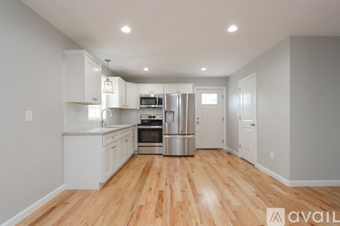 A kitchen with white cabinets and stainless steel appliances.