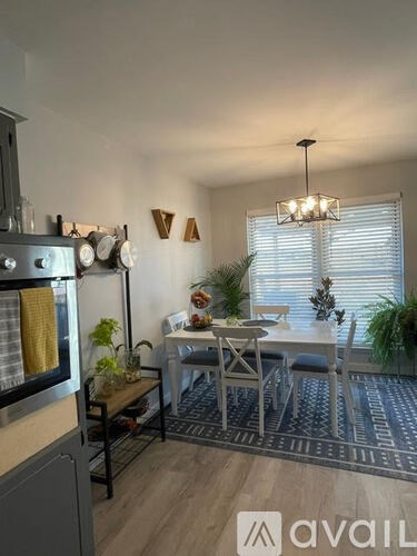 A kitchen with a dining table and chairs in the middle of the room.