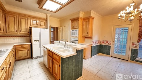 A kitchen with wooden cabinets and a white refrigerator.