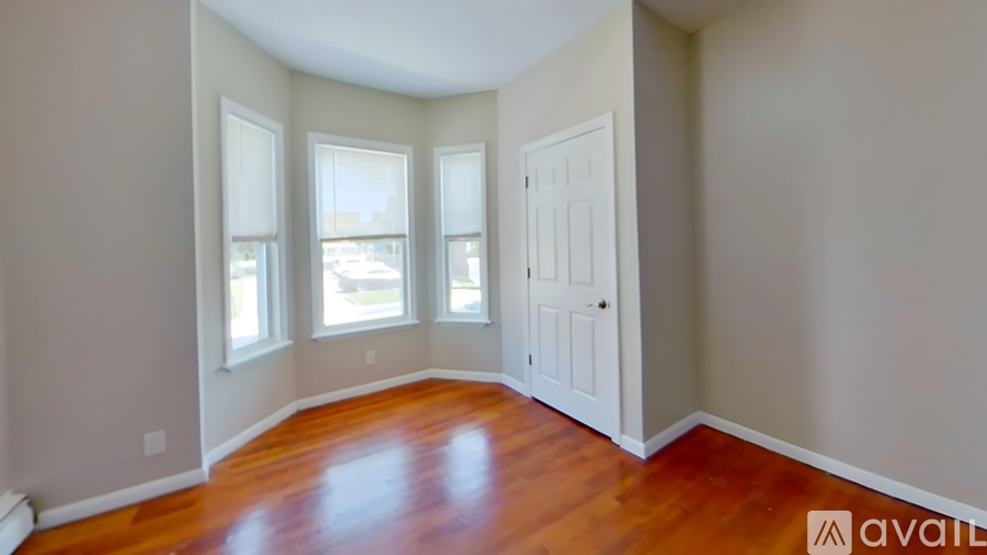 A room with wooden floors and a white door.
