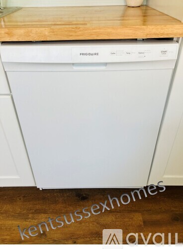 A white Prigidaire dishwasher in a kitchen.