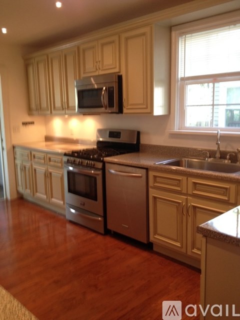 A kitchen with wooden cabinets and stainless steel appliances.