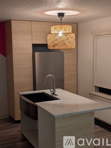 A modern kitchen with a sink and a refrigerator.
