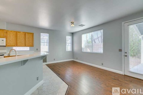 A kitchen with wooden cabinets and a countertop is available for rent.