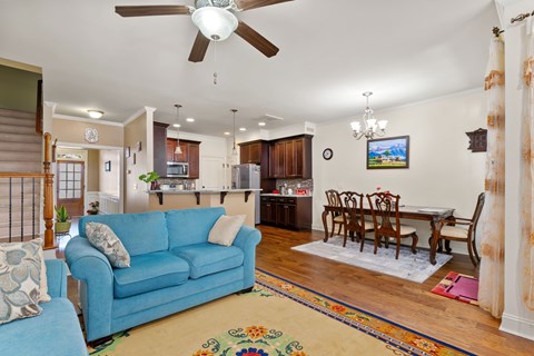 A blue couch is in the middle of a living room.
