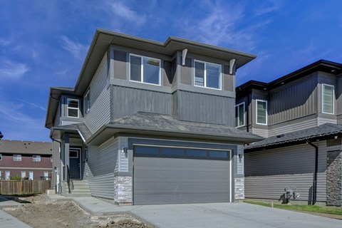 A modern house with a grey garage door.