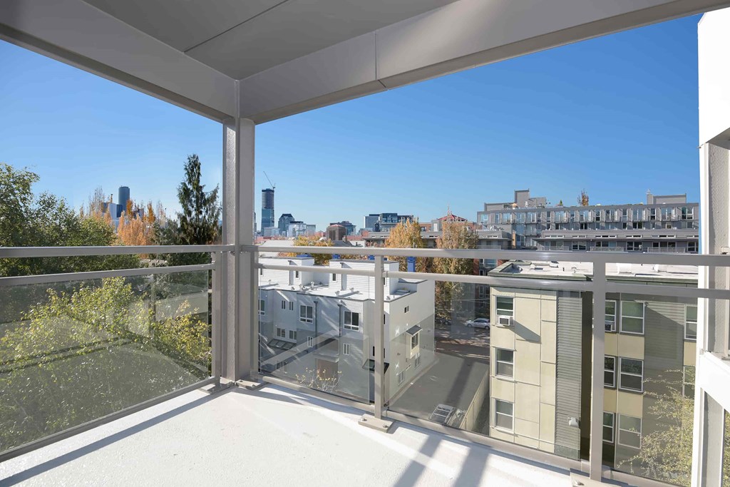 A balcony with a view of a city skyline.