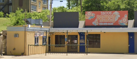 A yellow building with a sign that says "Pacheco" on it.