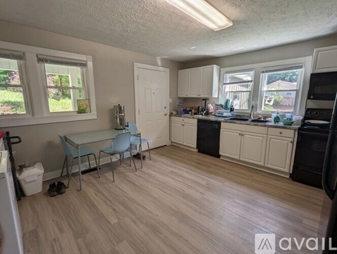 A kitchen with a table and chairs in the middle of the room.