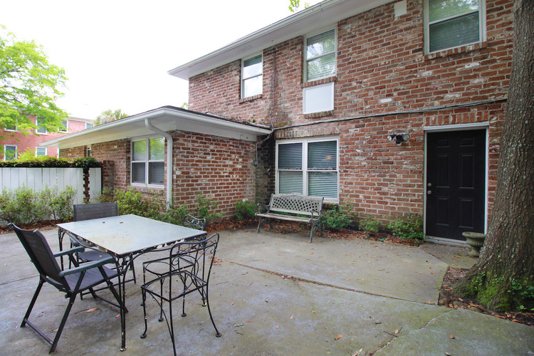 A brick house with a patio and a table.