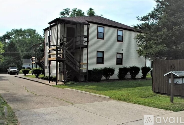 A two-story house with a balcony on the second floor.