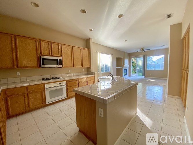 A kitchen with wooden cabinets and a white countertop.