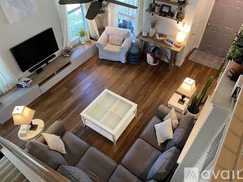 A living room with a grey couch and a white coffee table.