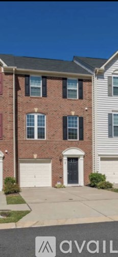 A red brick house with a white garage door.