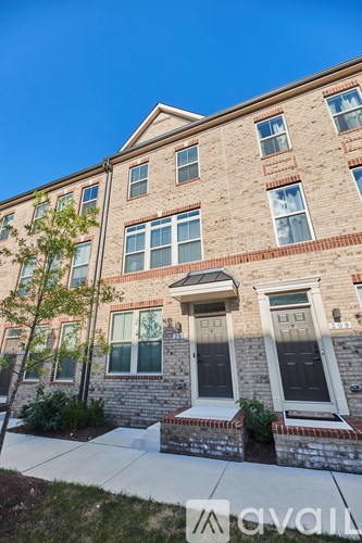 A row of townhouses with a clear blue sky above.