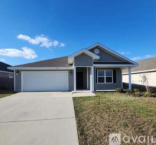 A house with a garage and a driveway is available for sale.