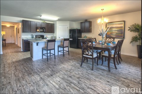A kitchen with a dining table and chairs.