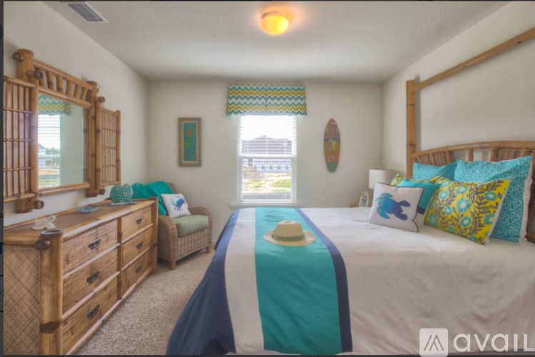 A bedroom with a bed, dresser, and mirror.