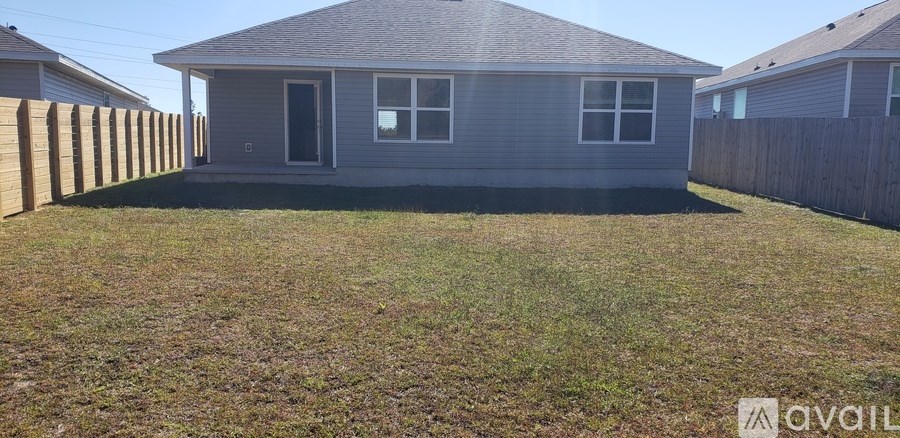 A small house with a fence in front of it.