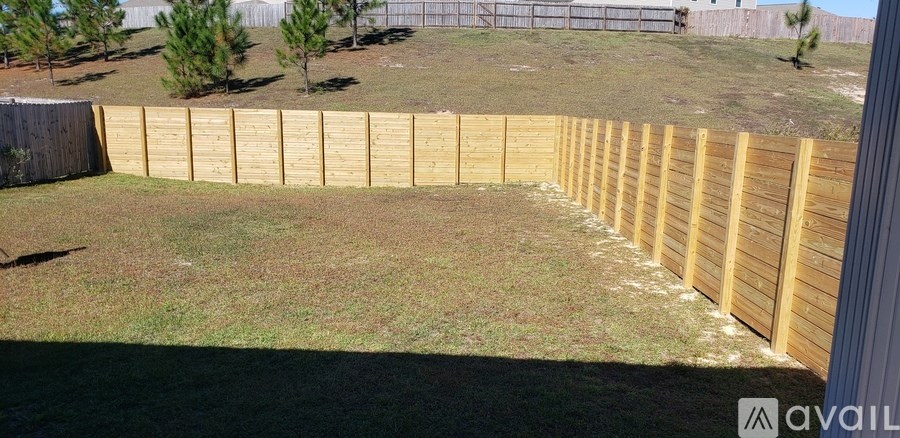A wooden fence in a backyard.