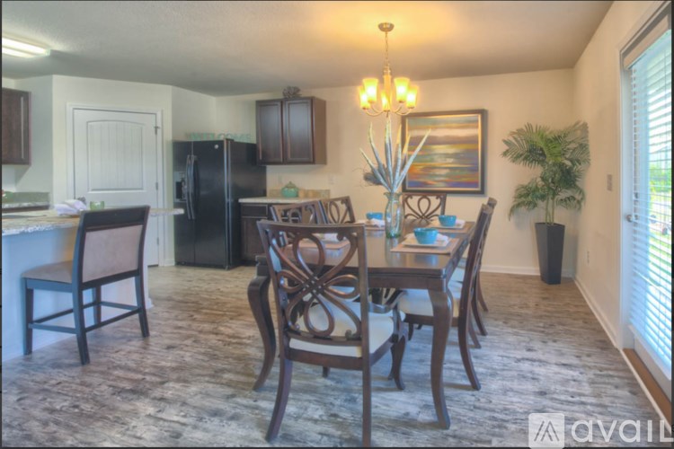 A dining room with a table set for six.