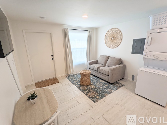 A living room with a couch, a table, and a television.