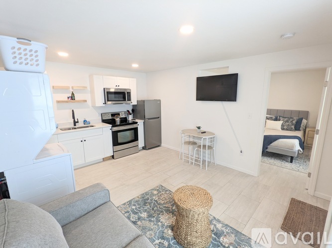 A kitchen with a refrigerator, microwave, and oven.