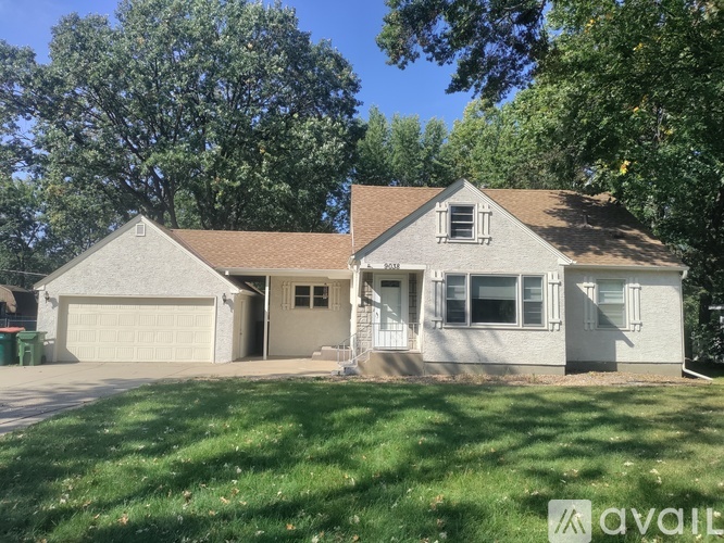 A house with a garage and a driveway is for sale.